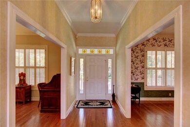 Entry hall is flanked by the formal living room/of