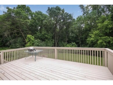 Huge deck overlooks wooded backyard
