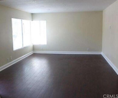 The wood floors in the family room are beautiful a