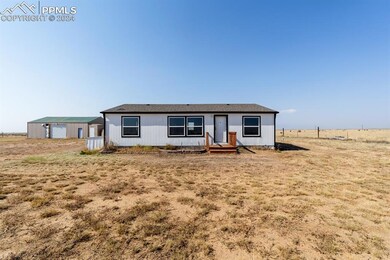 View of front of home featuring a rural view, a ga