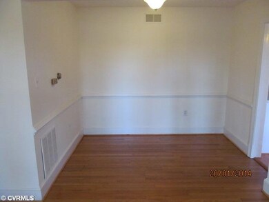 Dining Room - Dining room open to the living room with hardwood floors