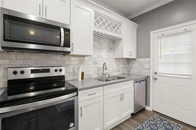 Kitchen with ornamental molding, a sink, tasteful 