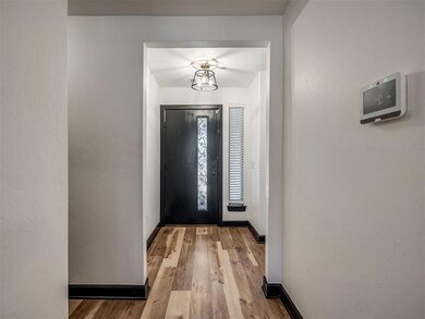 Entryway with light wood-type flooring and baseboards