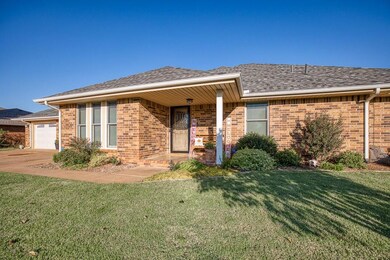 Ranch-style home with a garage and a front lawn