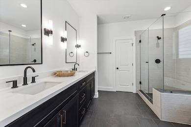 Ensuite bathroom complete with dual vanities, quar