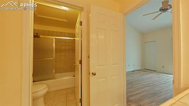 Bathroom with bath / shower combo with glass door,