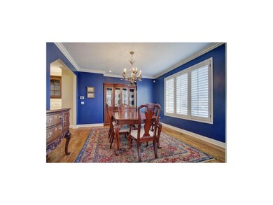 Spacious dining room w/ hardwood floors & plantati