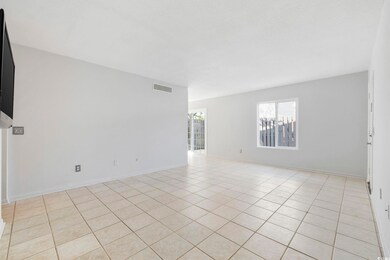 Empty room with light tile flooring