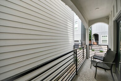 Cozy balcony with seating, enclosed by modern rail