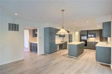 The expansive kitchen features abundant cabinetry, counter space and a eat in dining area with access to the three seasons room.