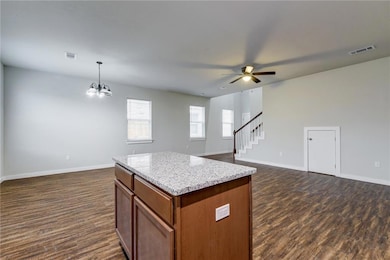Kitchen featuring open floor plan, baseboards, an