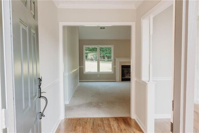 Corridor featuring crown molding and light wood-type flooring
