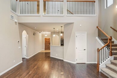 Unfurnished living room featuring a high ceiling,