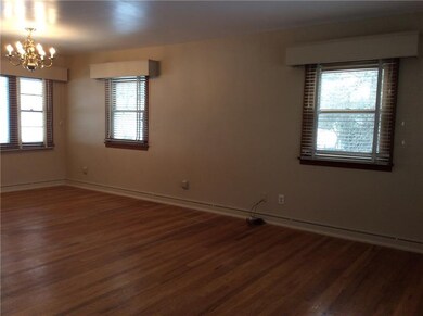 Dining room with hardwood flooring freshly painted plenty of windows to let in for sunlight