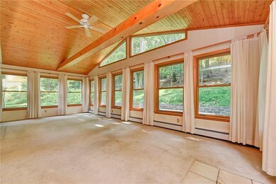 Light filled sun room shows off the surrounding wi