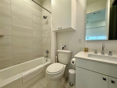 Full bathroom with shower / bath combo and vanity