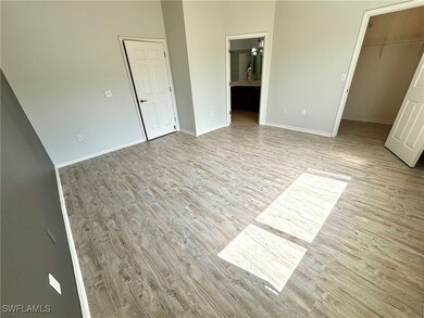Unfurnished bedroom with a spacious closet, basebo