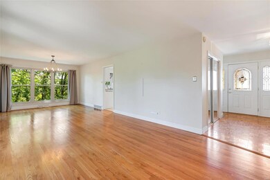Spacious living area 1 with hardwood and entrance 