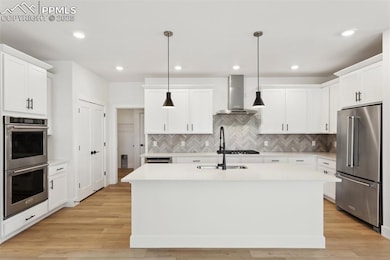 Kitchen featuring white cabinetry, stainless steel