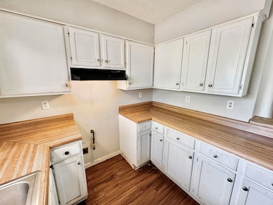 Kitchen featuring under cabinet range hood, white 
