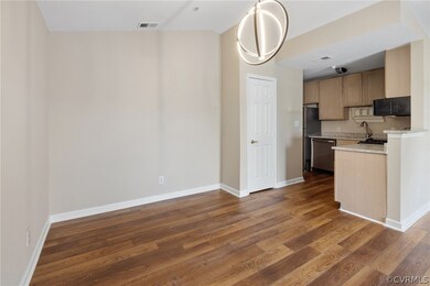 Kitchen with hardwood / wood-style floors, vaulted