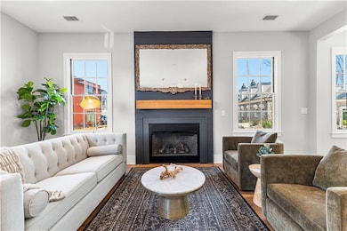 Living room featuring visible vents, wood finished