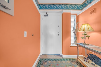 Entrance foyer featuring baseboards and tile patte