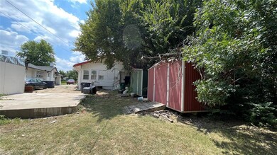 View of yard with a storage shed and a patio