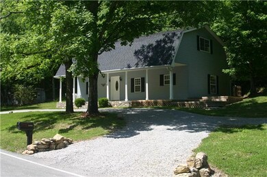 Another view of the property, note the front porch and swing, plus a deck on the side for grilling out!  Plenty of parking, and room for a future garage.