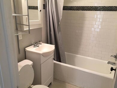 Unit B Full bathroom with vanity, toilet, shower /