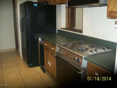 Galley kitchen with Ceramic tile floor.
