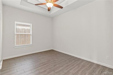 Unfurnished room featuring ceiling fan and light hardwood / wood-style floors