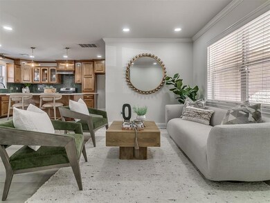 Living room featuring sink and ornamental molding
