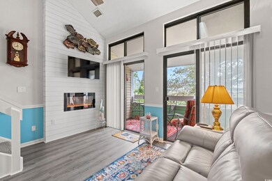 Living room featuring wood-type flooring, high vau