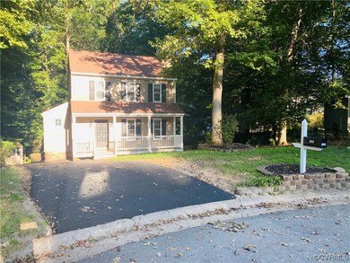 Colonial home featuring covered porch