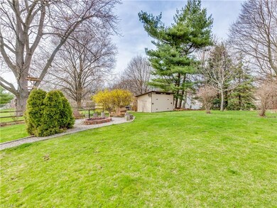 Backyard has firepit area, large storage shed and walking path.