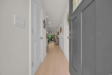 Hallway with recessed lighting and light wood-style floors