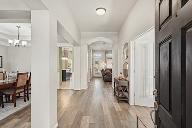 As you step inside, you’re welcomed by a blend of tile and wood flooring, soaring ceilings, and a graceful arched walkway leading to the family room. To your right is a private study, while both formal living and dining areas are conveniently located to your left.
