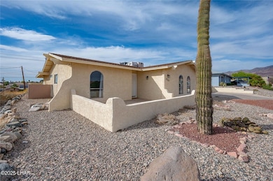 View of home's exterior with stucco siding and fen