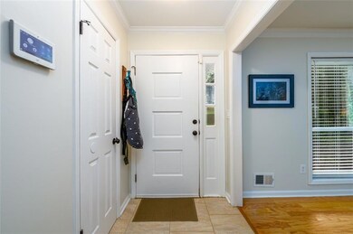 Entryway with crown molding and hall closet