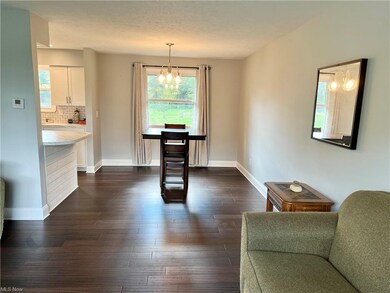 Living room opens to the dining room with a window