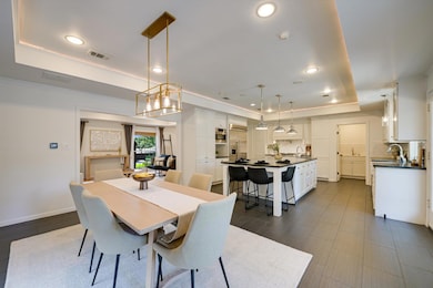 Dining space featuring a tray ceiling and recesse
