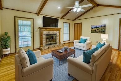 Large living room with vaulted ceiling and firepla