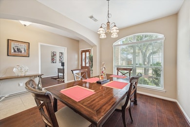 VIEW OF DINING TOWARD THE FORMAL ENTRY- LARGE WINDOW LOOKS OUT TO FRONT YARD