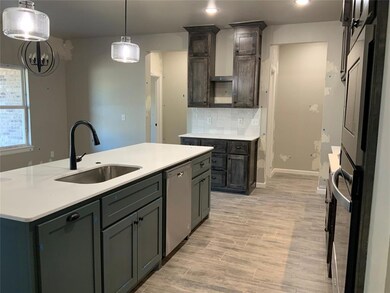 Kitchen with pendant lighting, backsplash, stainle