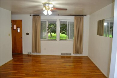 LIVING ROOM All of the original genuine oak hardwood flooring throughout the full main level has been lovingly refinished. The front facing bay window welcomes in lots of natural light...
