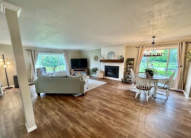 Open floor plan combines the dining and living areas comfortably. Very spacious with beautiful luxury vinyl plank flooring. Enjoy a little fire in the electric fireplace too. Great usable space!