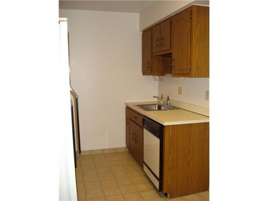 Kitchen. Neutral wood cabinets and ceramic tile fl