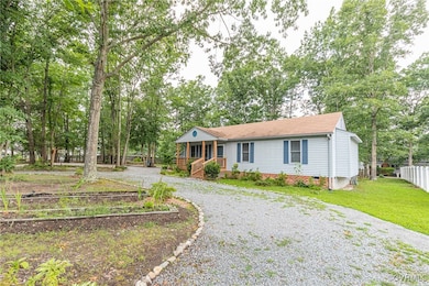 View of front facade with driveway, covered porch,
