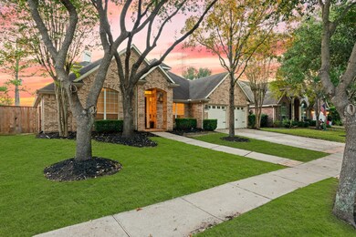 This beautiful home offers incredible curb appeal with large shade trees, a traditional brick elevation, and a covered front porch with handsome coach lighting.